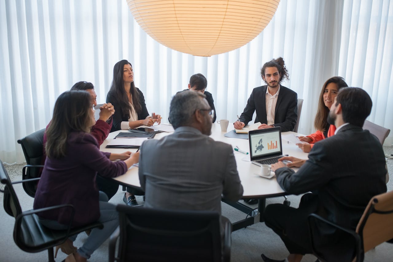 A diverse group of professionals discussing business strategy in a modern office setting.